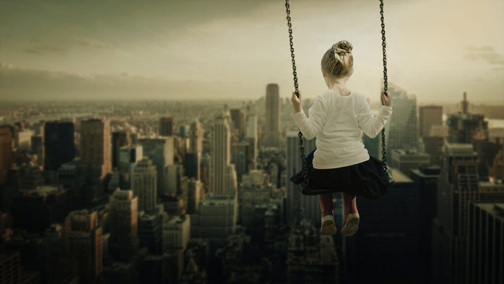 A child playfully swinging above the skyscrapers of a city business district